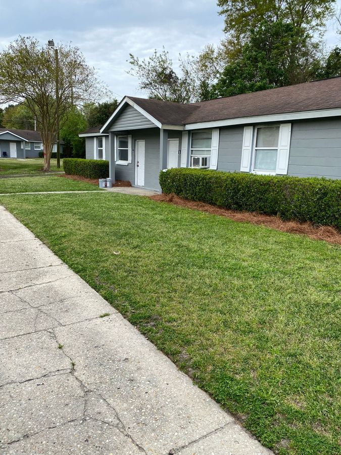 Gray painted duplex exterior with white trim and shutters